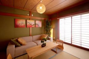 a living room with a couch and a table at のまちのスミカ 宿 Nomachi Sumika in Kanazawa