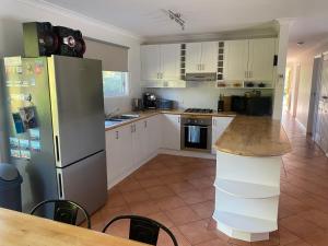 a kitchen with a stainless steel refrigerator and a counter at 6 Wrights Close, Mallacoota in Mallacoota +4 photos