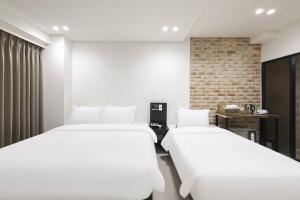 Ένα ή περισσότερα κρεβάτια σε δωμάτιο στο Haeundae HaeRium Hotel