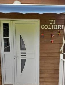 a front door of a building with ait colibral sign at Villabadlou Ti-Colibri in Trois-Rivières +41 photos