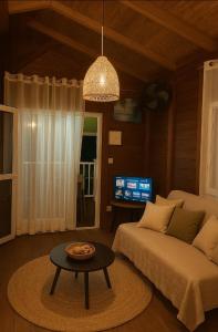 a living room with a couch and a table at Villabadlou Ti-Colibri in Trois-Rivières