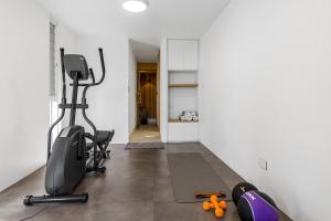 an empty room with a gym with exercise equipment at The Pool House in Lennox Head