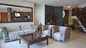 Una sala de estar con dos sofás y una mesa de café. en FLAT ILHA FLAT HOTEL, en Ilhabela