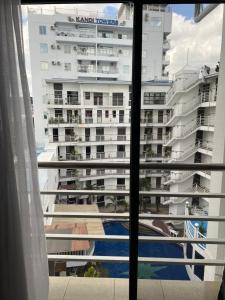 a view of a large building from a window at Grosvenor Square Kandi near walking street in Angeles