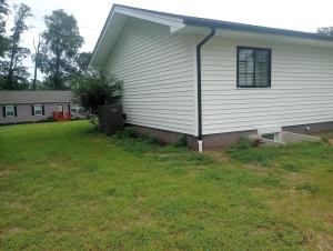 a side view of a house with a yard at Brand new apartment in seaford  +8 photos