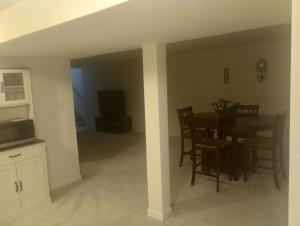 a kitchen and dining room with a table and chairs at Brand new apartment in seaford 
