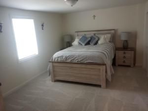 a bedroom with a bed with pillows and a window at Brand new apartment in seaford 