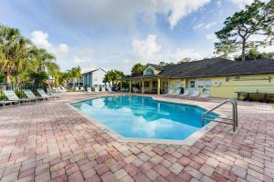 a swimming pool in front of a house at Florida Fun! Family Condo with Pool, 8 Mi to WDW in Kissimmee