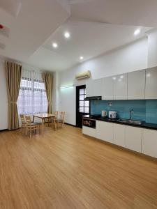 a kitchen and dining room with a table and chairs at Tuti Apartment in Da Nang