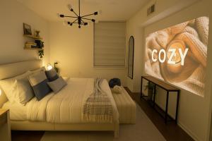 a bedroom with a bed with a coco sign on the wall at Hala Tysons in McLean