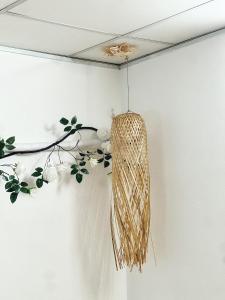 a hanging rattan light hanging on a wall at Vân Kì 1 in Hue +12 photos