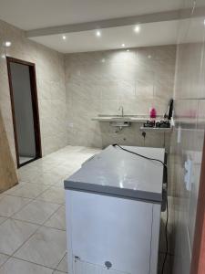 a kitchen with a counter and a sink in a room at Casa Paraiso in Beberibe +12 photos