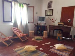 a living room with a chair and a fireplace at Cabaña Catelmo in Colalao del Valle