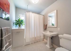 a bathroom with a sink and a shower curtain at Villa with Heated Pool & SPA in Los Angeles +20 photos