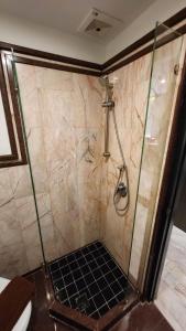 a shower with a glass door in a bathroom at Max Residence in Pattaya +46 photos