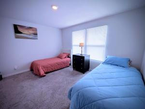 a bedroom with two beds and a window at Home away from Home! in Des Moines