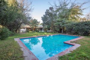 an image of a swimming pool in a yard at Lodge Los Naranjos de Mallarauco in Melipilla