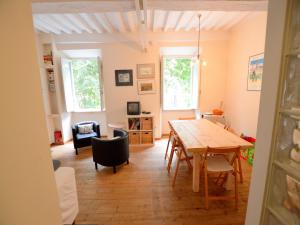 a dining room and living room with a table and chairs at Charming Mansion in Lucca in Lucca