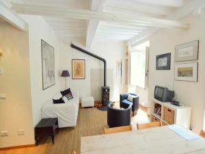 a living room with a couch and a tv at Charming Mansion in Lucca in Lucca
