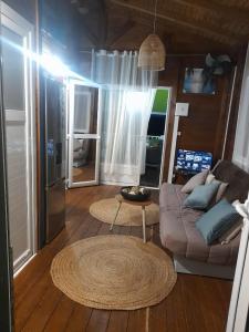 a living room with a couch and a table at Villabadlou Ti-Colibri in Trois-Rivières