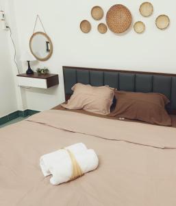 a bed with a towel on the floor in a room at Vân Kì 1 in Hue