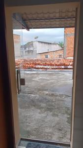 a window with a view of a parking lot at Alugo Suítes Confortáveis para COP 30 in Belém +4 photos