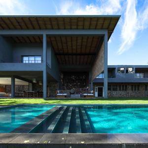 an external view of a house with a swimming pool at Kurundu House in Digana