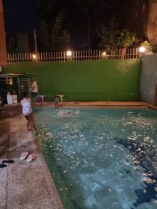 a young boy standing in a swimming pool at night at Tivoli Condominium in Cebu City