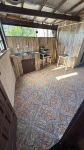 a room with a tiled floor with a table at Casa Praia dos Anjos in Arraial do Cabo +3 photos