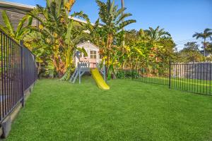 a backyard with a playground with a slide at Bridgeport pet-friendly Pool Getaway in Margate