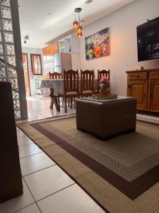 a living room with a couch and a table at AREIA DE TAPERAPUAN - 200 MTS da PRAIA - ORLA NORTE in Porto Seguro