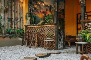 a room with a table and chairs and a painting at Nostalgia DongVan Homestay Ha Giang in Dồng Văn
