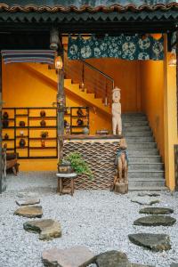 a building with stairs and a statue of a bear at Nostalgia DongVan Homestay Ha Giang in Dồng Văn +17 photos