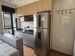 a kitchen with a stainless steel refrigerator in a room at Max Jardim São Paulo in São Paulo