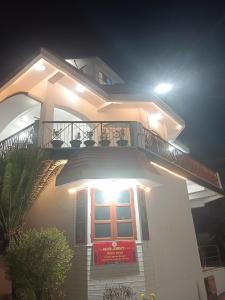 a large white house with a balcony at night at Entire Villa in Darbhanga in Darbhanga +14 photos