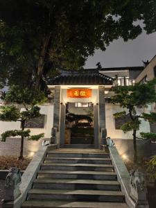a building with stairs leading up to the entrance at Huiyuan Mansion Guangzhou in Guangzhou