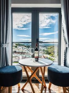 a table with a bottle of wine and two chairs at Mây Hoa Tiên Villa - House in Da Lat