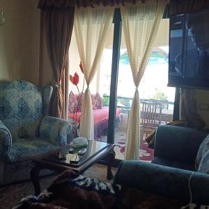 a living room with two chairs and a coffee table at شقة للايجار in Sharm El Sheikh +4 photos
