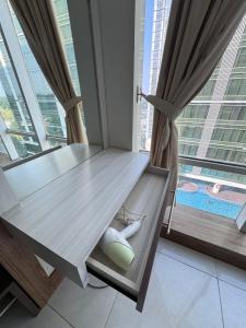 a dining table in a room with a large window at Mataram City Apartment 700 Sadewa in Yogyakarta