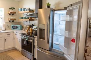 a refrigerator with its door open in a kitchen at Downtown Mount Dora Hideaway in Mount Dora