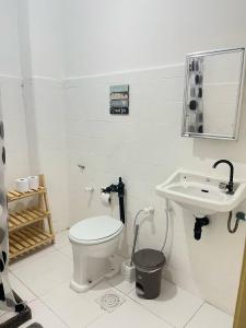 a bathroom with a toilet and a sink at Stúdio no Centro- Lapa, Consulado, Praia e Metrô! 1101 in Rio de Janeiro