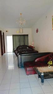 a living room with two beds and a couch at Villa Higland No 7 P Berastagi View in Berastagi +16 photos