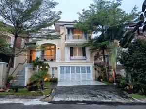 a large white house with a garage at Omah Kumpul Sentul in Bogor