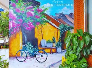 a painting of a bike parked next to a house with flowers at Ancient Beach Boutique & Spa - Beachfront Hotel in Hoi An