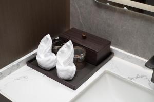 a pair of white shoes and a box on a table at Mehood Lestie Hotel, Nanjing Xinjiekou Subway Station in Nanjing +21 photos