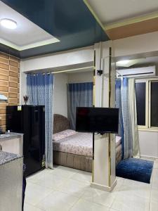 a bedroom with a bed and a flat screen tv at شقة للايجار in Sharm El Sheikh +10 photos