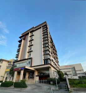 a tall apartment building with a staircase in front of it at District 21 Hotel in Iloilo City