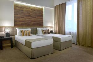 Кровать или кровати в номере Minotel Barsam Suites