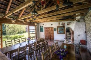 a dining room with a table and chairs and a fireplace at Penzion U Dračice in Nová Bystřice