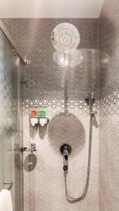 a shower in a bathroom with a glass door at The Meriton in Jāmb +90 photos